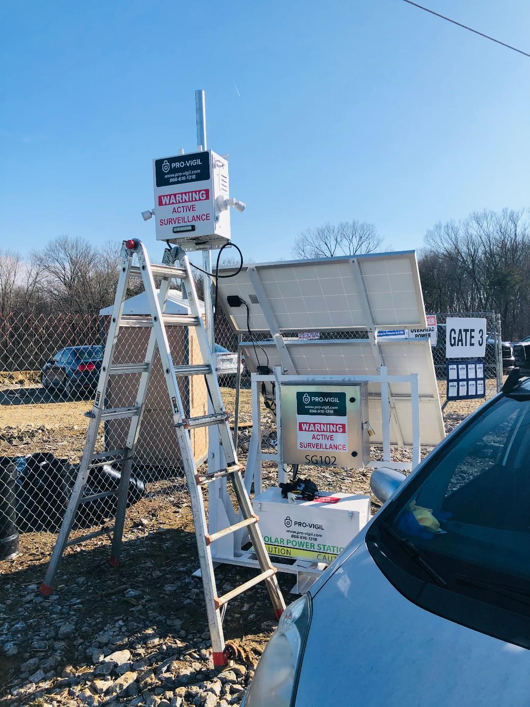 PRO-VIGIL mobile solar surveillance unit with cameras, warning signs, and solar panels.