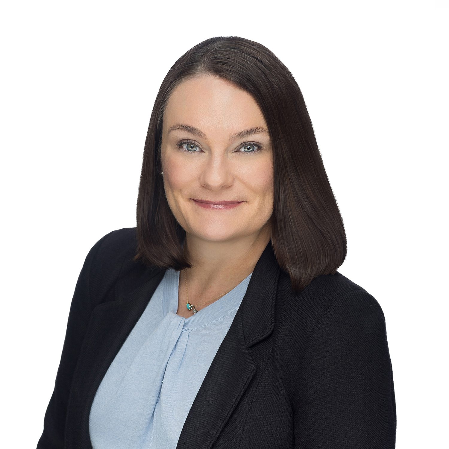 Smiling woman's professional headshot in black blazer, blue top.