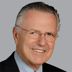 Smiling senior man with gray hair and glasses.