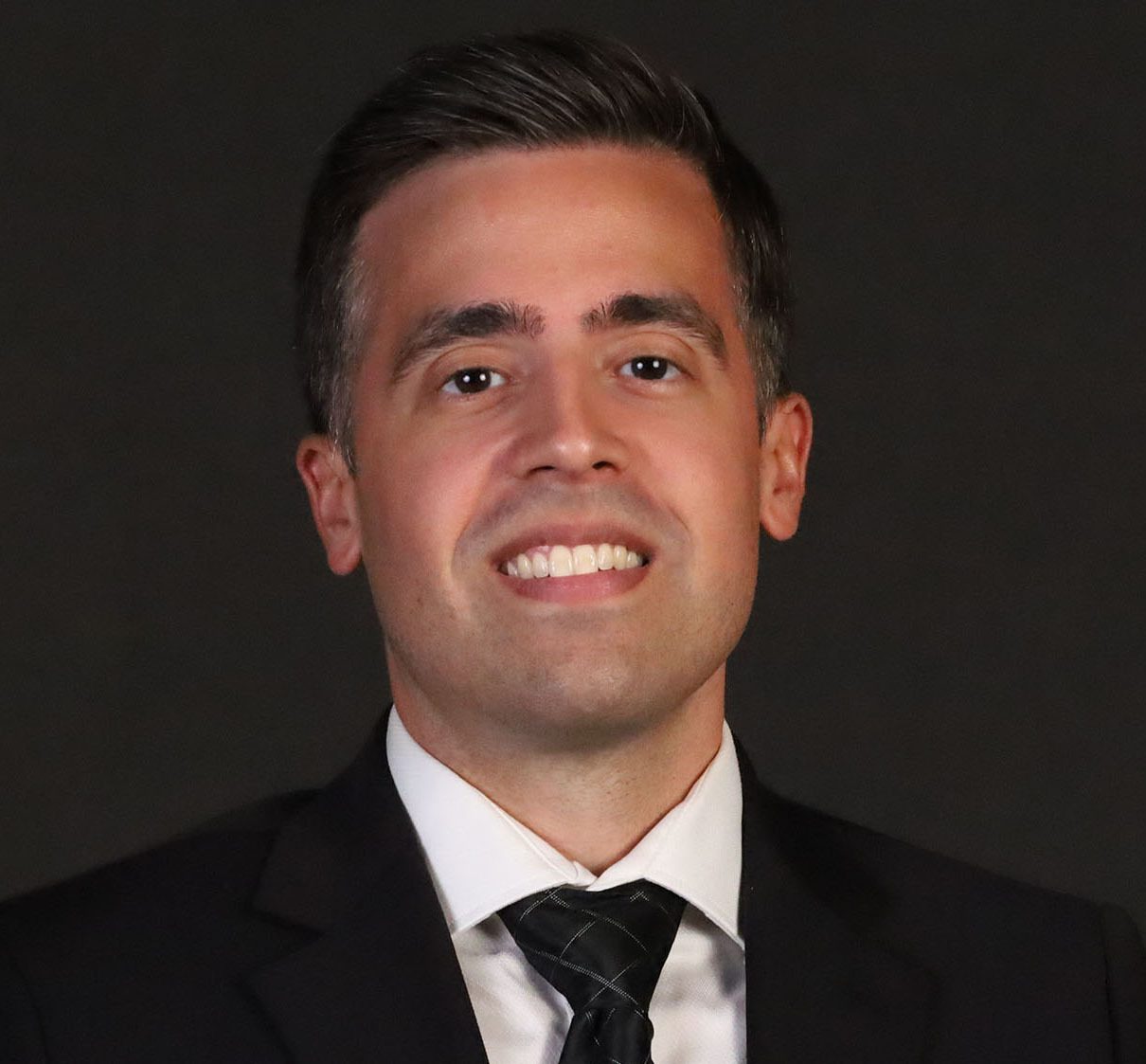 Smiling man in a suit and tie.