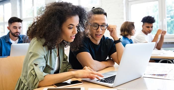 Personal computer, Jheri curl, Glasses, Table, Laptop, Interaction, Smile, Desk