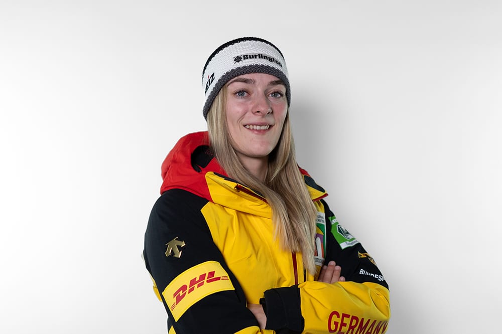 Smiling woman in German winter jacket and headband.