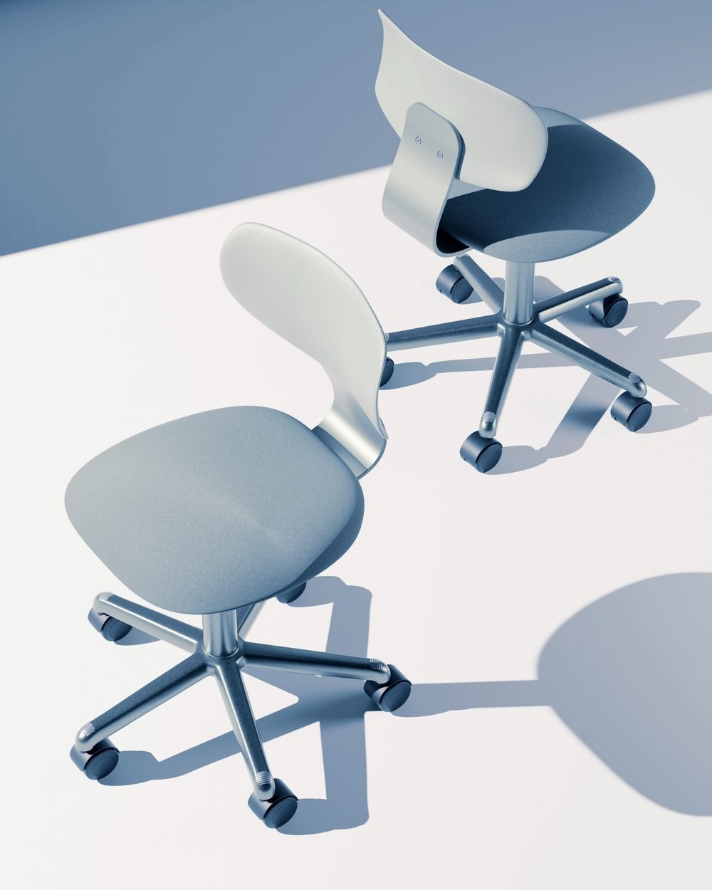Two modern light blue and white office chairs casting shadows on a white surface.