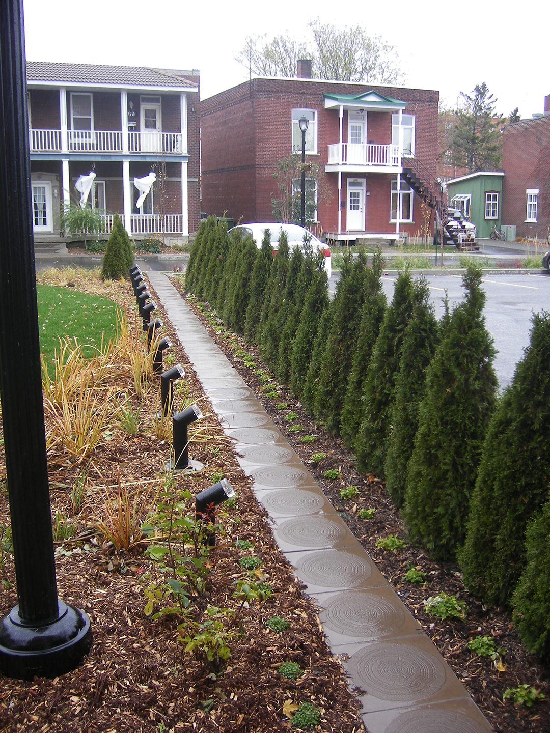 Road surface, Land lot, Urban design, Plant, Building, Window, Sky, Tree, House, Grass