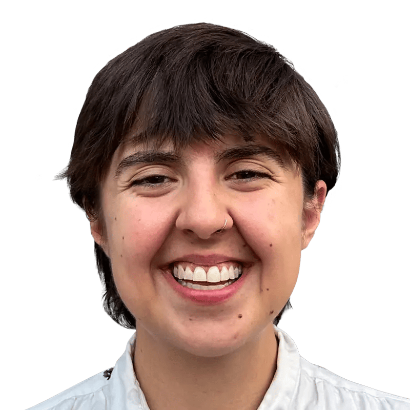 Smiling person with short brown hair, a nose ring, and a wide grin.