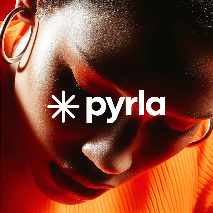 Close-up of woman's dark skin face in warm red light, with Pyryla logo.