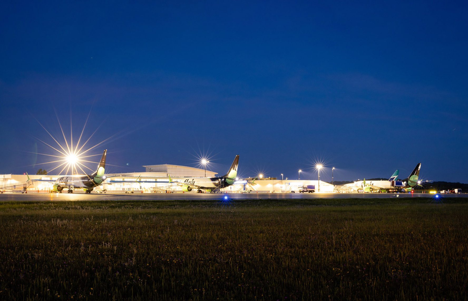an image of planes lined up at YKF during the night