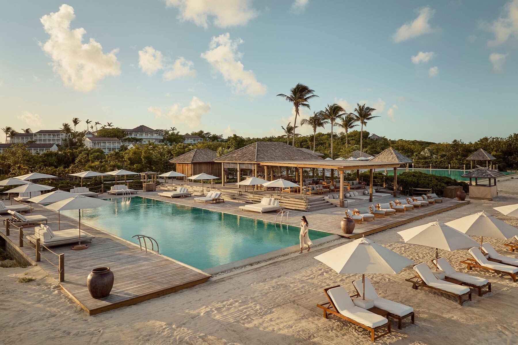 Swimming pool, Outdoor furniture, Seaside resort, Cloud, Sky, Water, Property, Building, Tree, Sunlounger