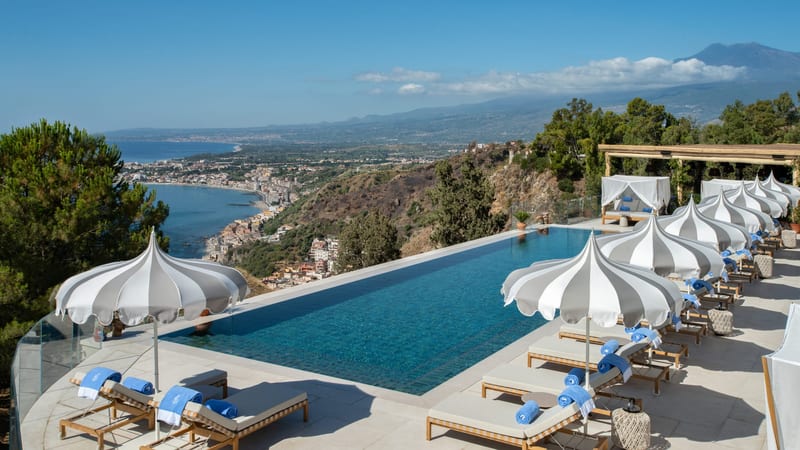 Swimming pool, Seaside resort, Outdoor furniture, Water, Sky, Cloud, Azure, Building, Sunlounger