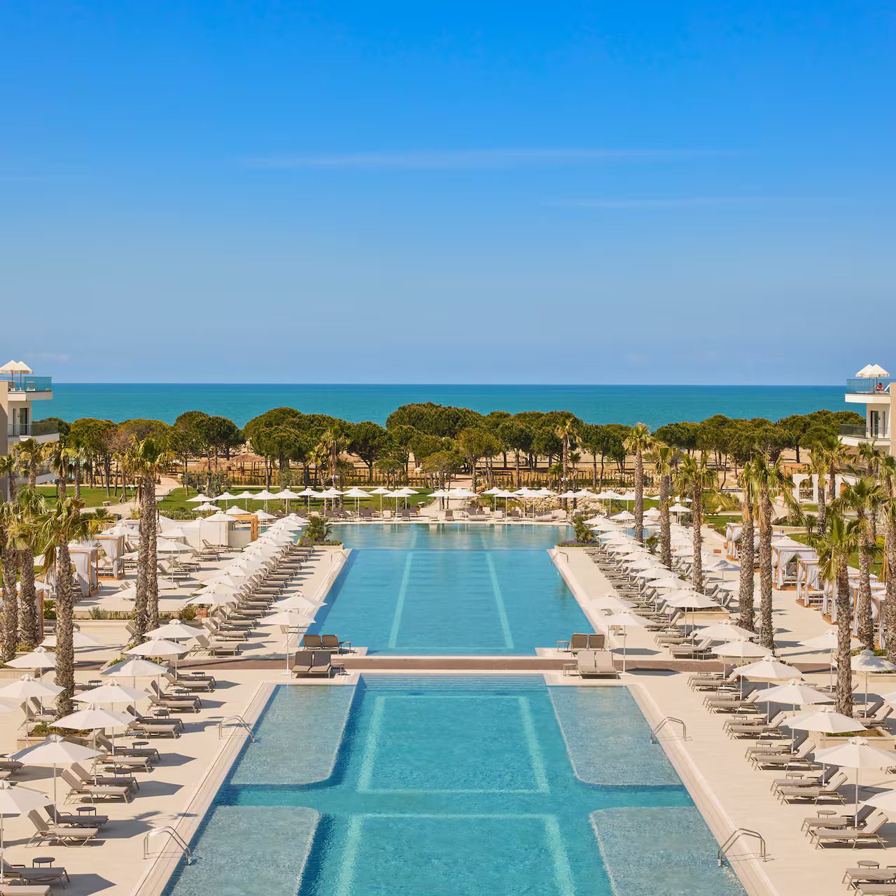 Coastal and oceanic landforms, Swimming pool, Outdoor furniture, Seaside resort, Water, Sky, Property, Building, Azure, Leisure