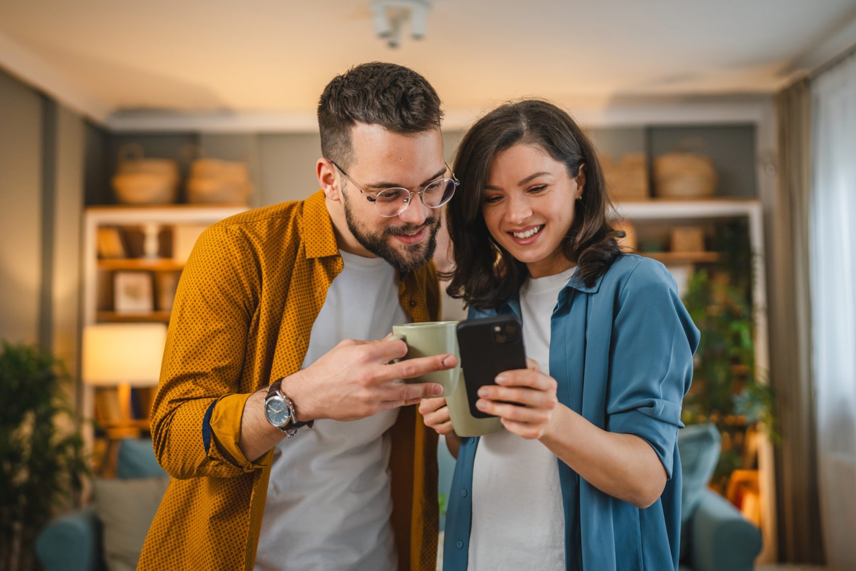 Happy couple looks at phone.