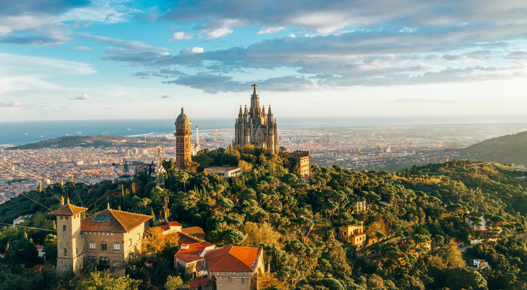 Sagrat Cor church on Tibidabo hill overlooking Barcelona and the Mediterranean Sea, sunset clouds.