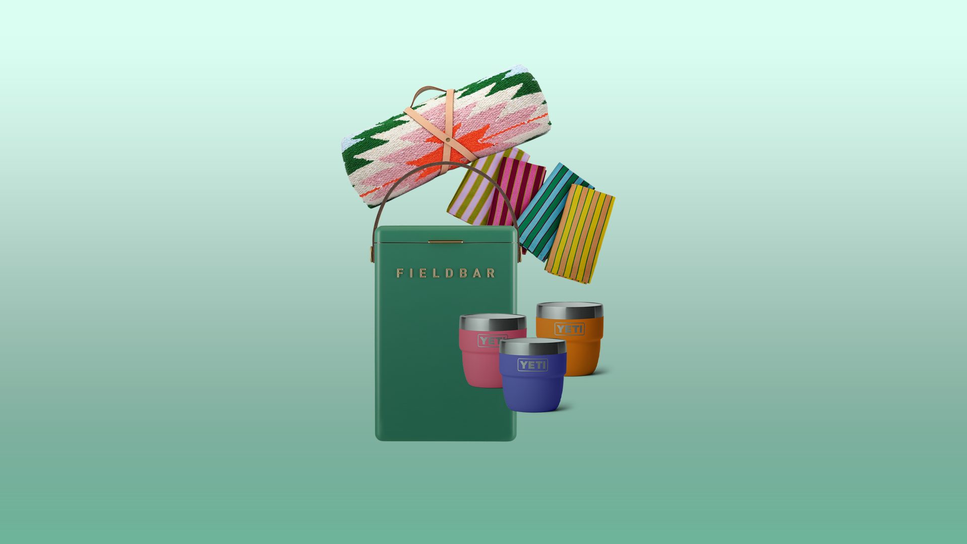 Fieldbar cooler, patterned blanket, striped towels, and colorful Yeti cups.