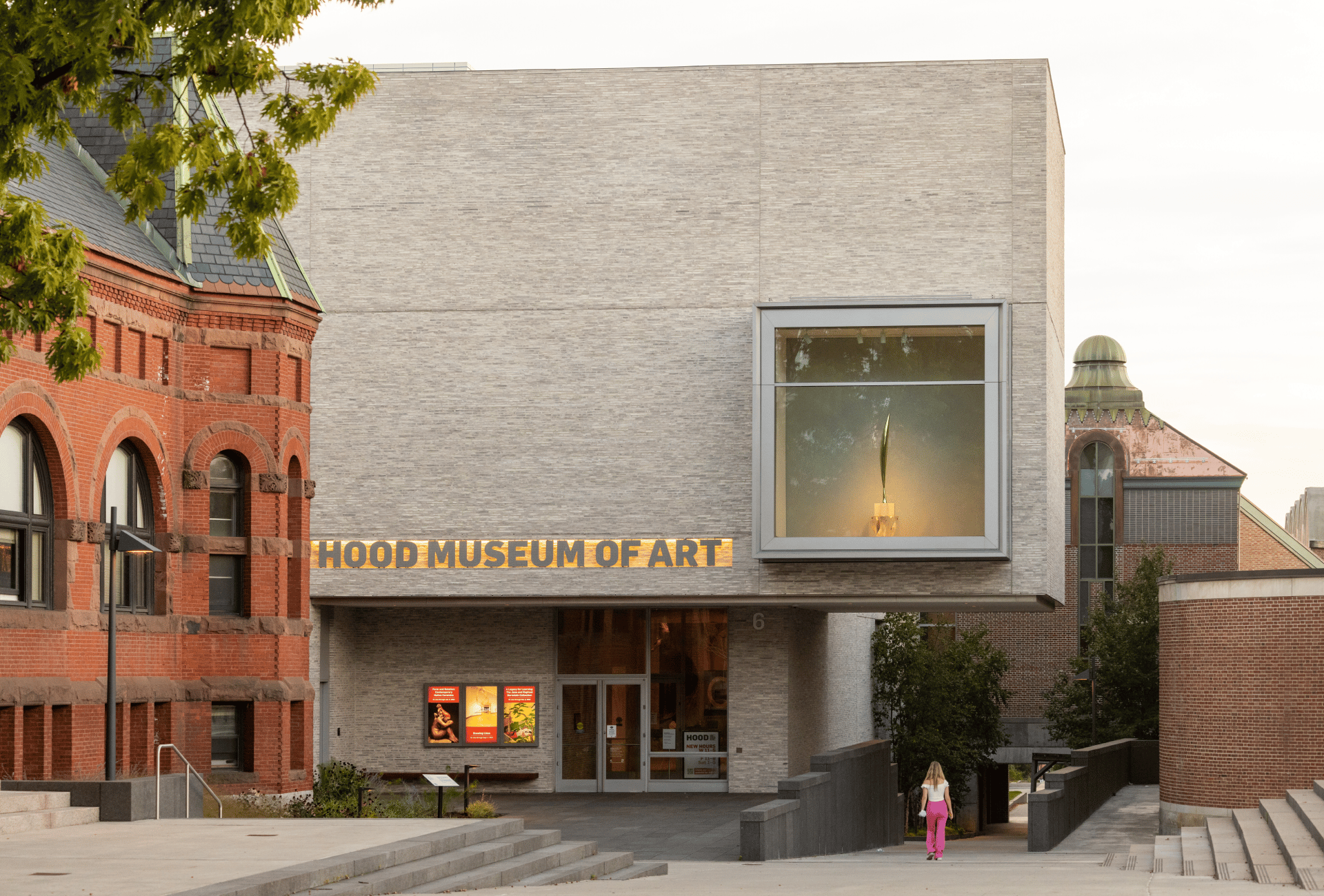 Hood Museum of Art: modern light brick building next to older red brick, person walking.