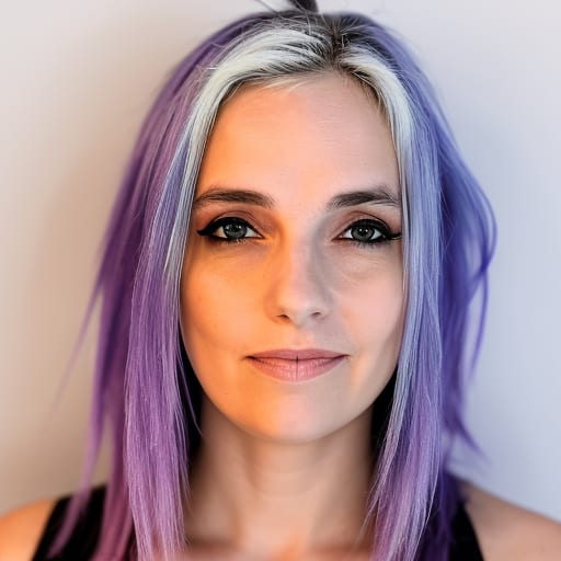 Close-up of a woman with purple and white hair, green eyes, and black eyeliner, smiling slightly.