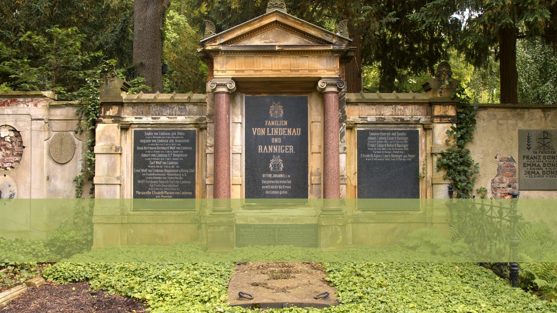 Ornate cemetery monument for the Von Lindenau and Ranniger families, surrounded by trees and ivy.