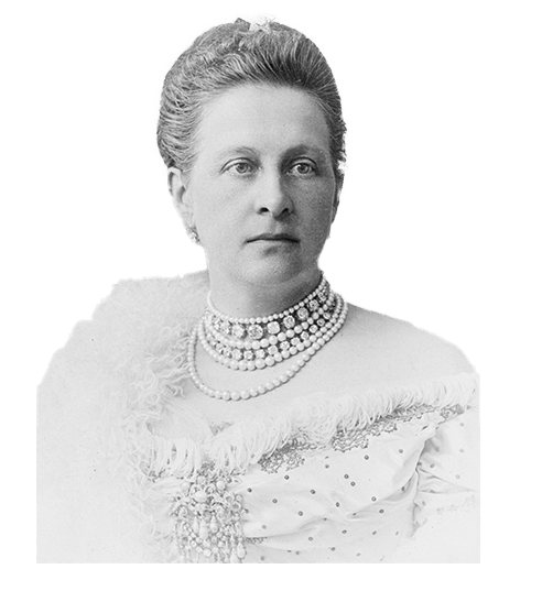 Black and white portrait of an elegantly dressed woman with multiple pearl necklaces and a large brooch.