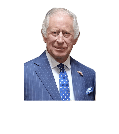 King Charles III smiling, wearing a blue suit and blue tie.