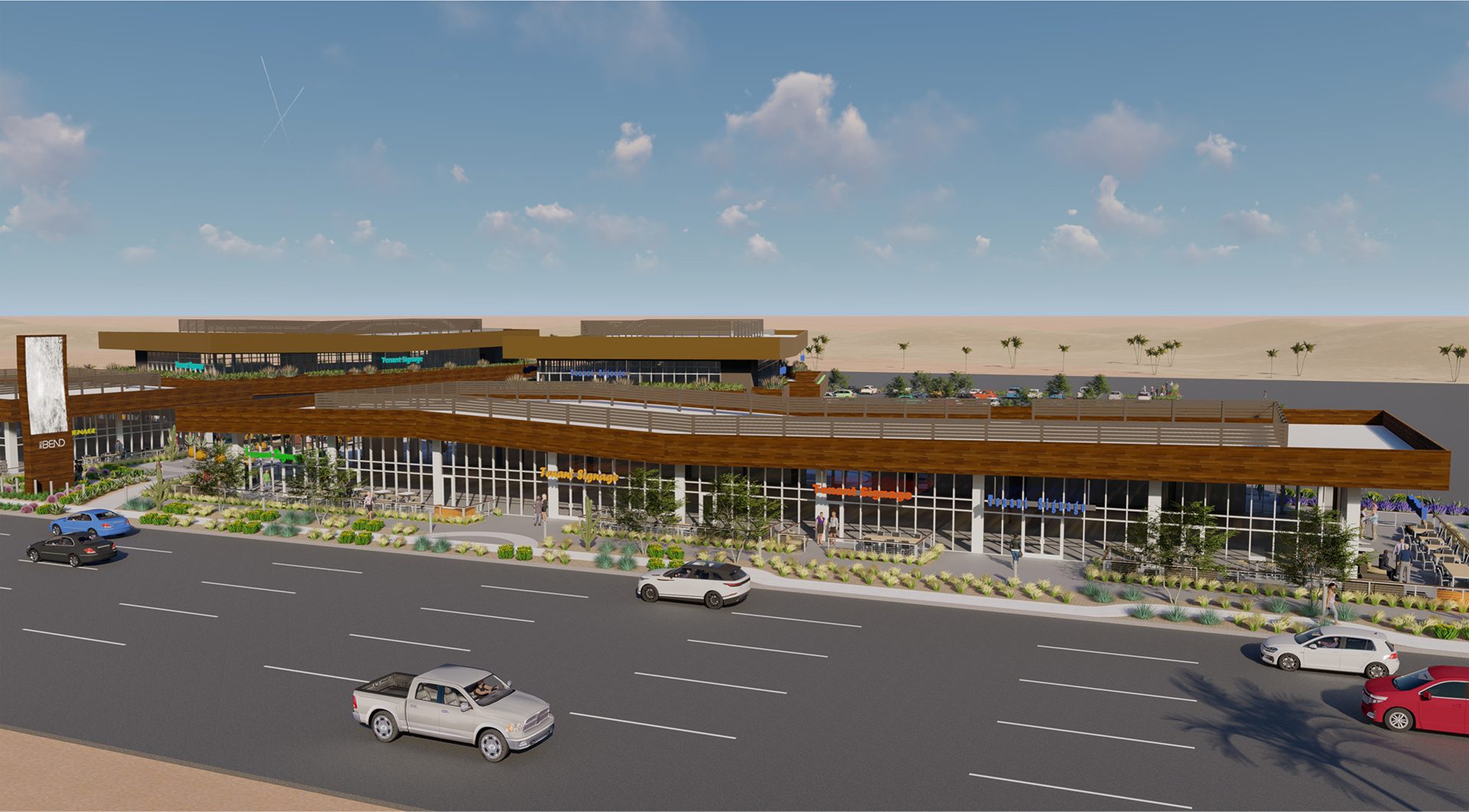 Modern multi-story commercial complex, road with cars, outdoor seating, and desert background.