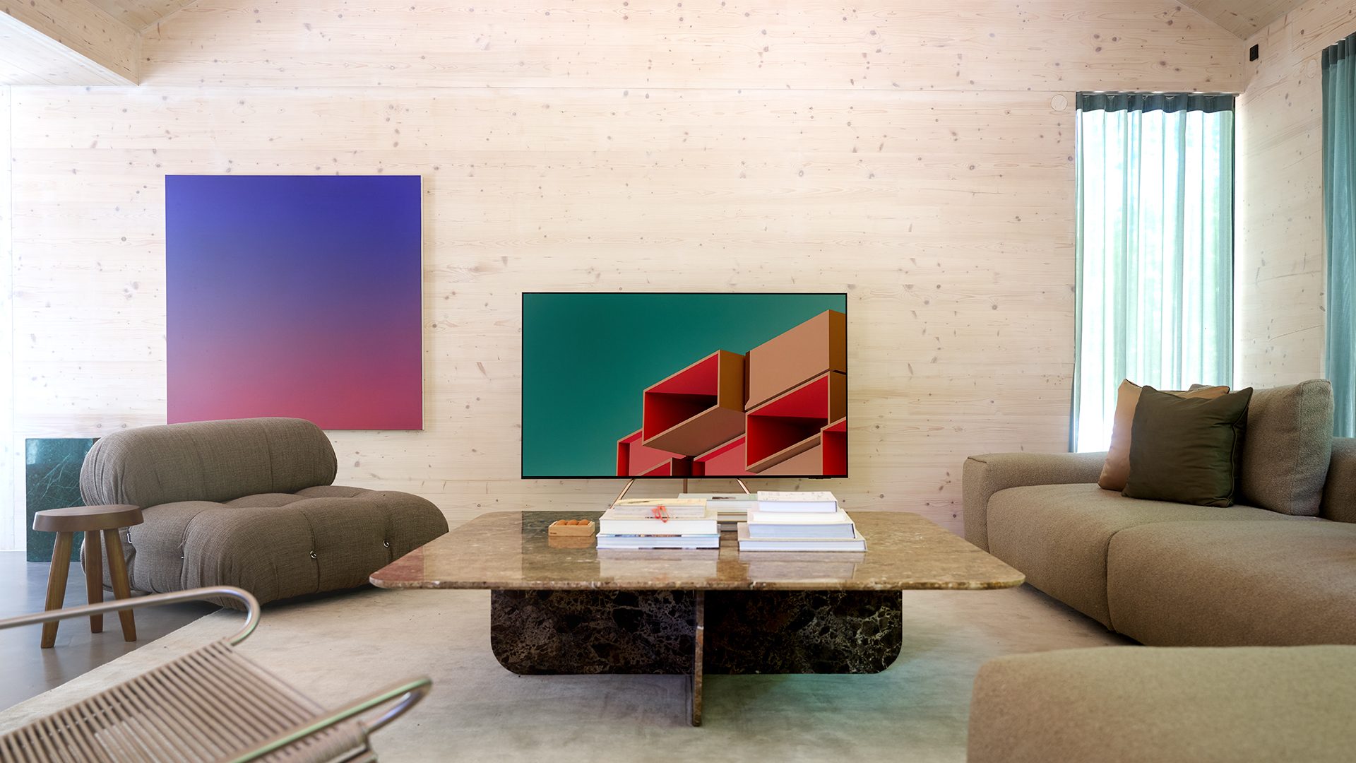 Modern living room with wooden walls, gradient art, TV, marble coffee table, and neutral sofas.