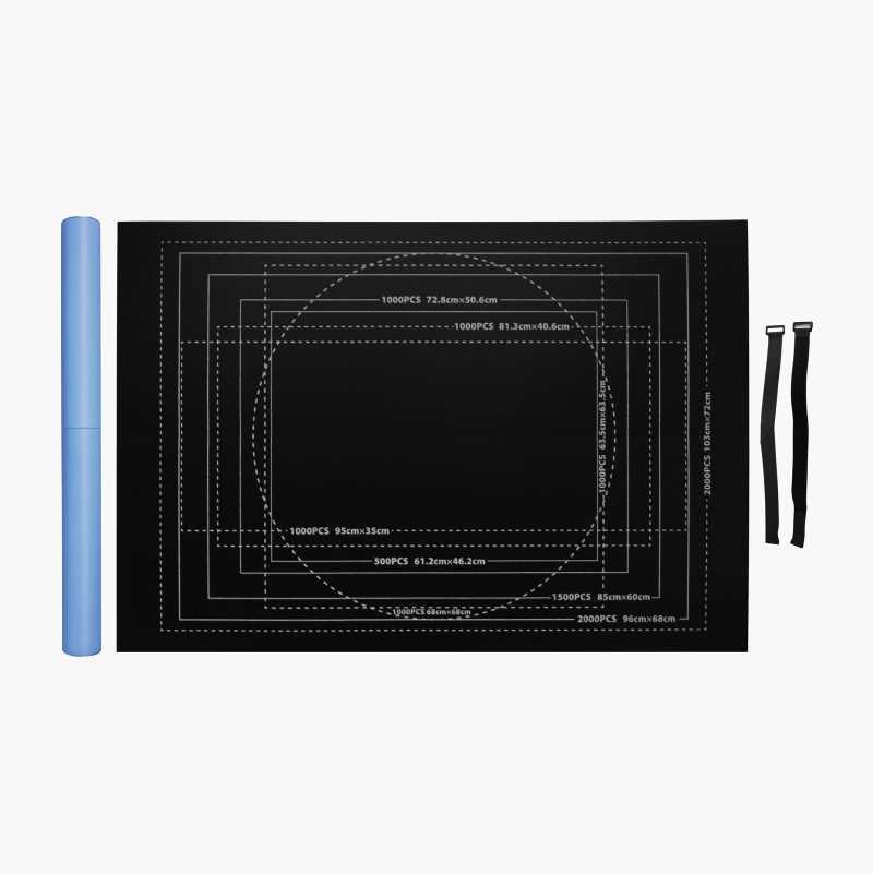 Black puzzle mat with puzzle size guides, a blue roll, and two black straps.
