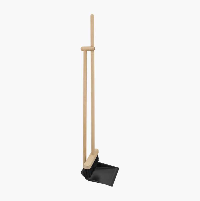 A wooden broom and black dustpan set, standing upright.