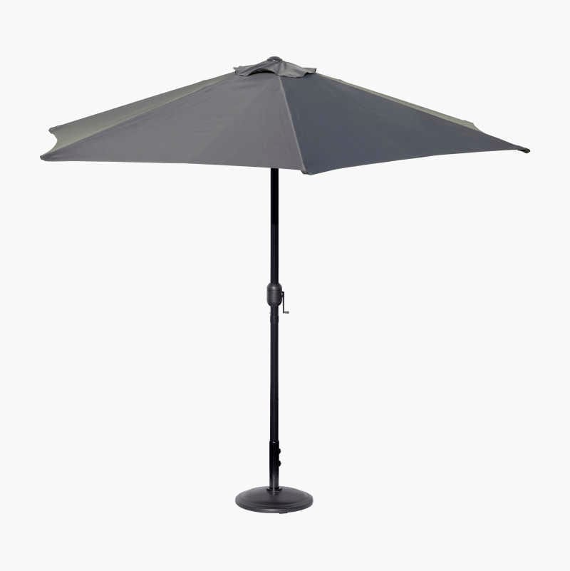 Grey patio umbrella with black stand.