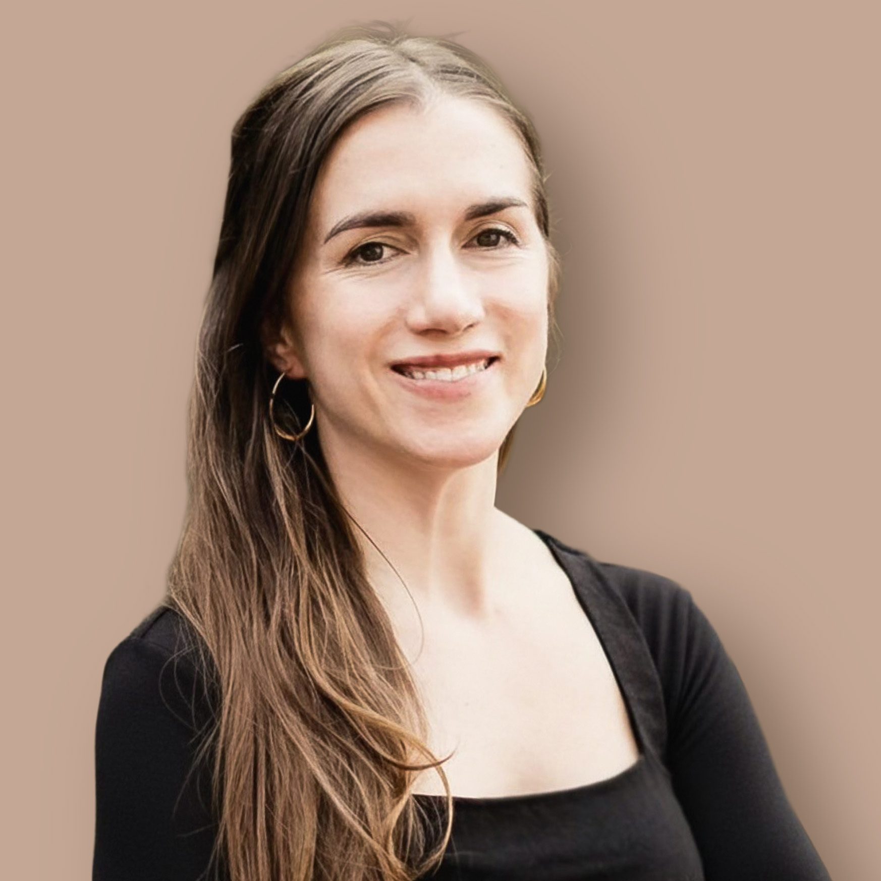 Smiling woman with long brown hair and hoop earrings, wearing a black top.