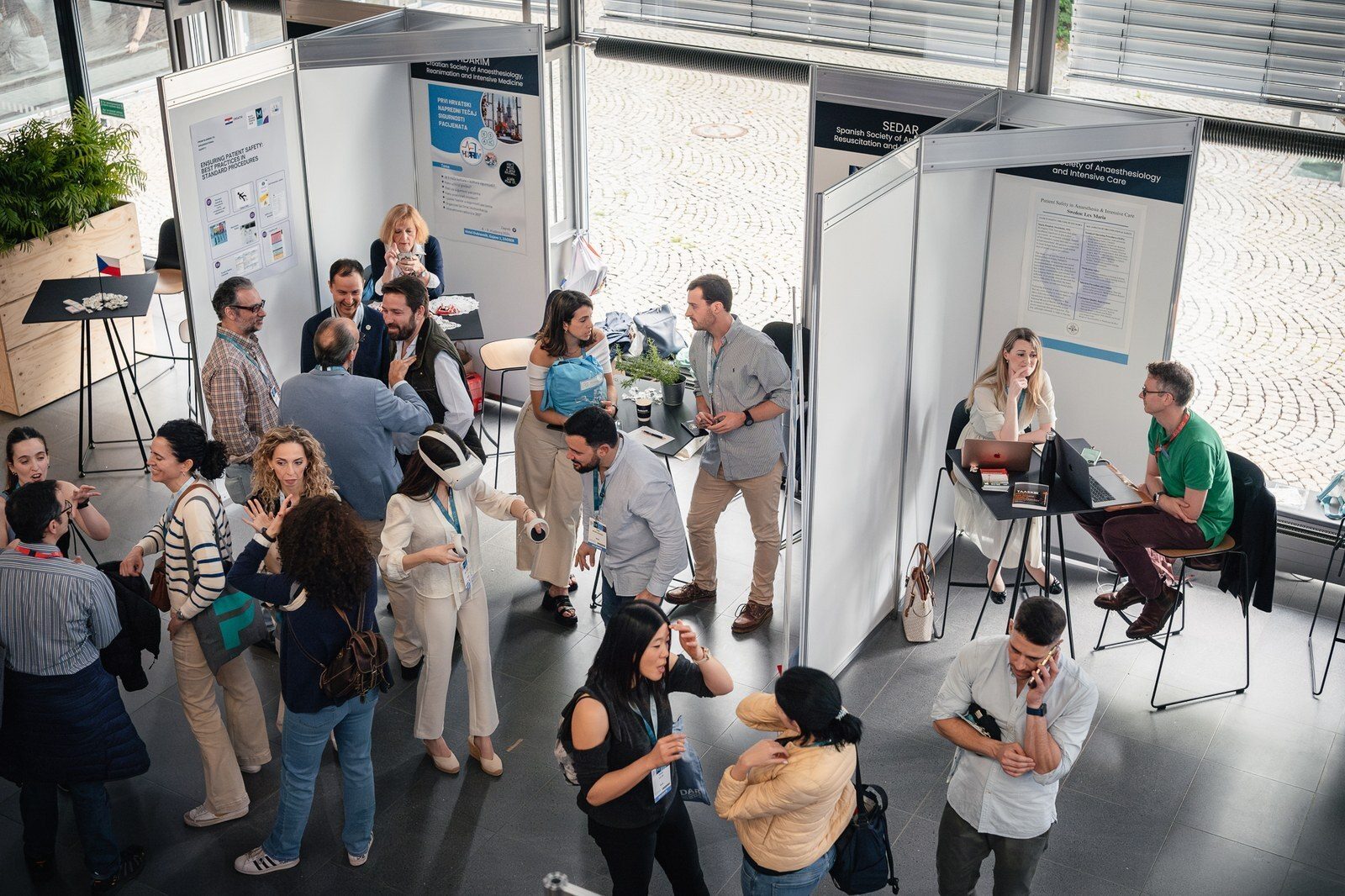 Attendees at a medical conference, viewing displays and trying VR headsets.