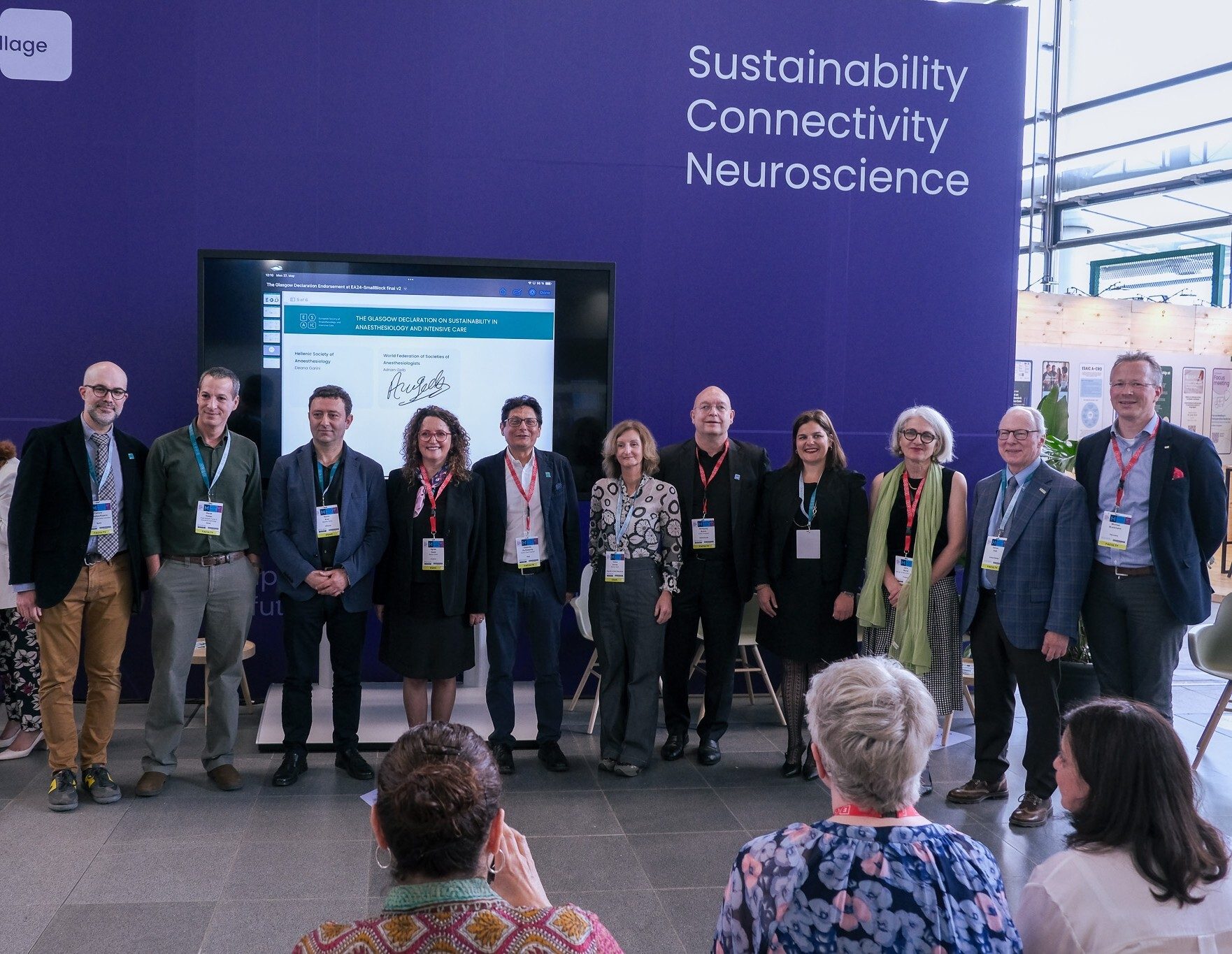 Group presenting "Glasgow Declaration on Sustainability" with "Sustainability" sign.