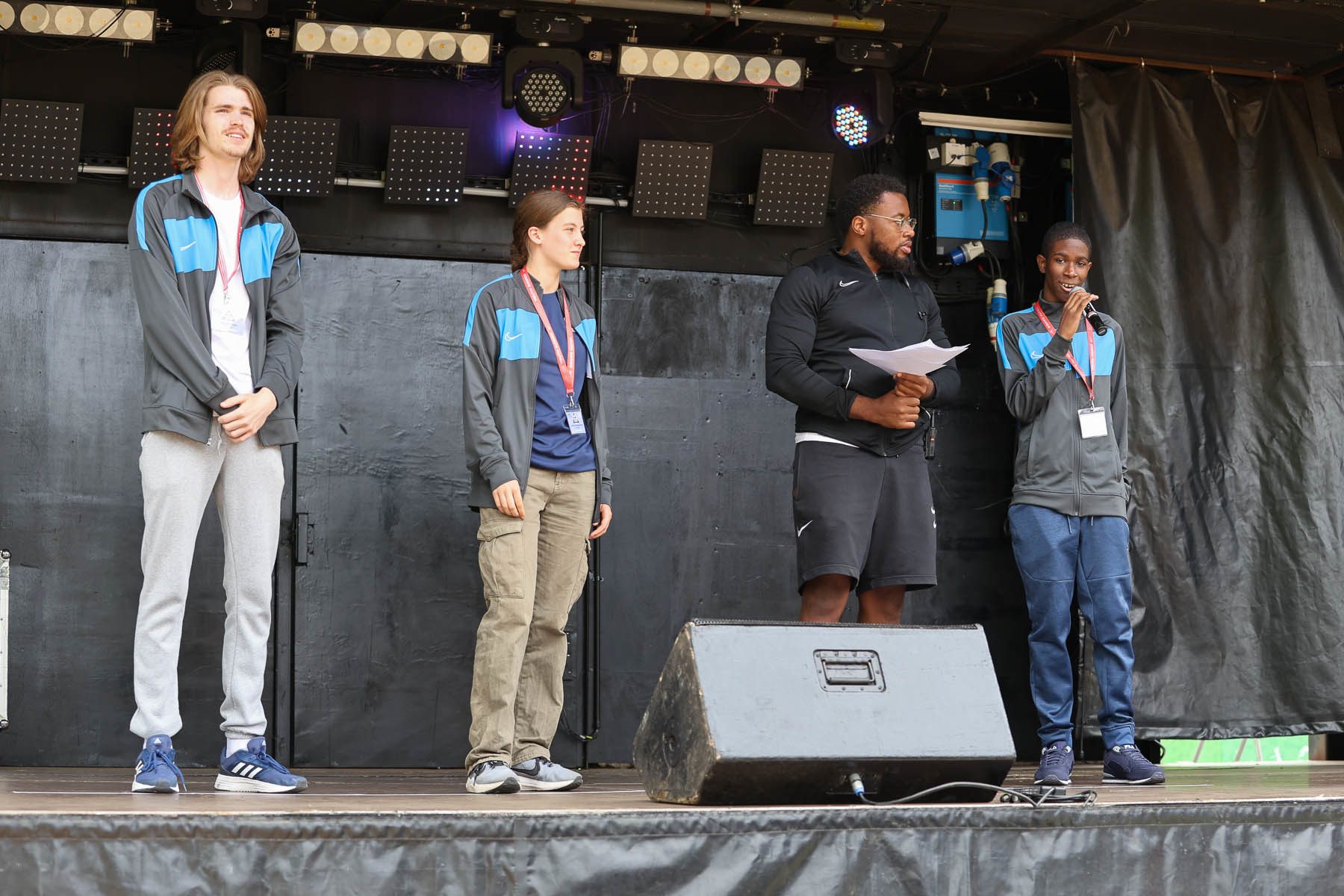 1 white male, 1 white female and 2 black males on stage