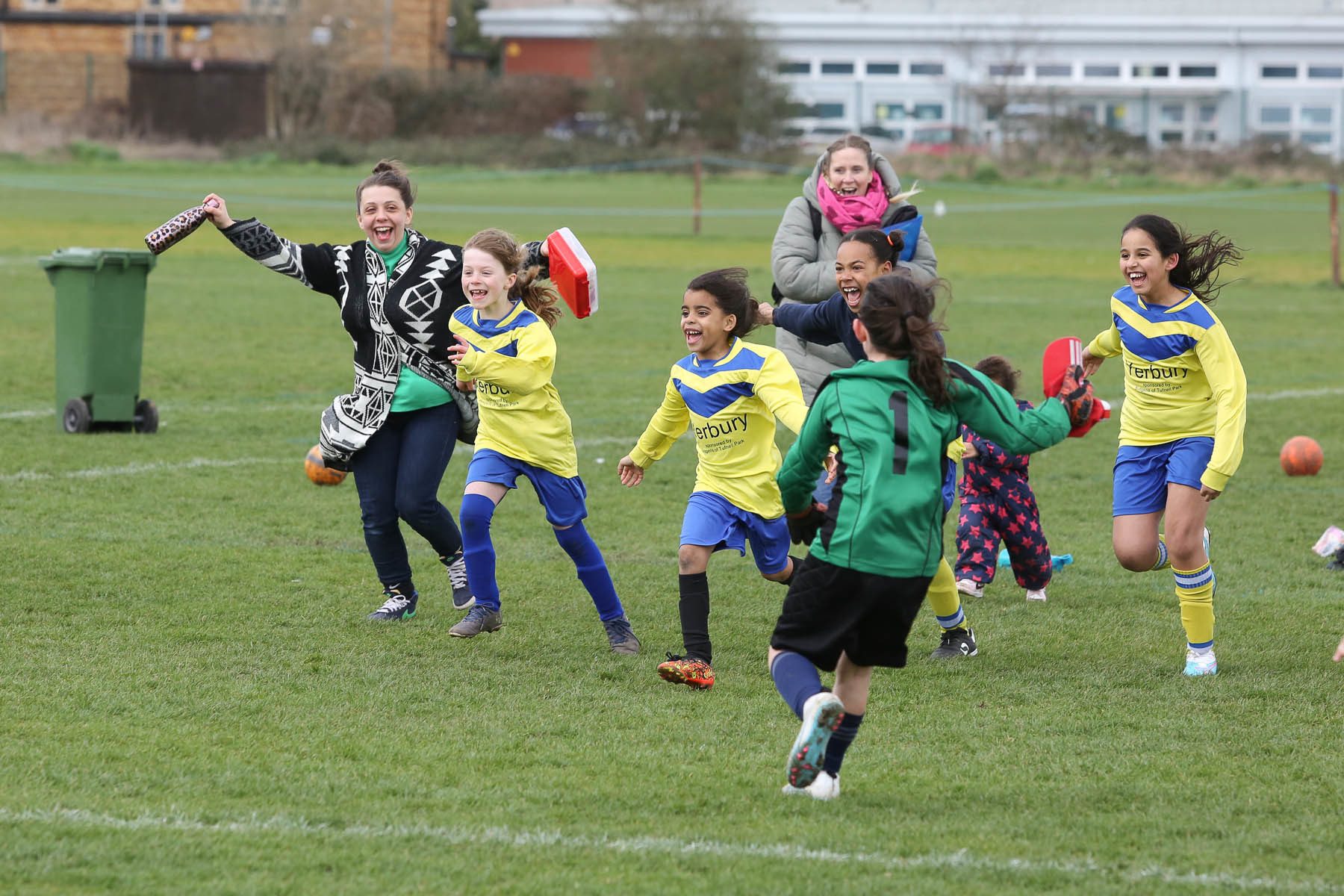 female footballers run in excitement