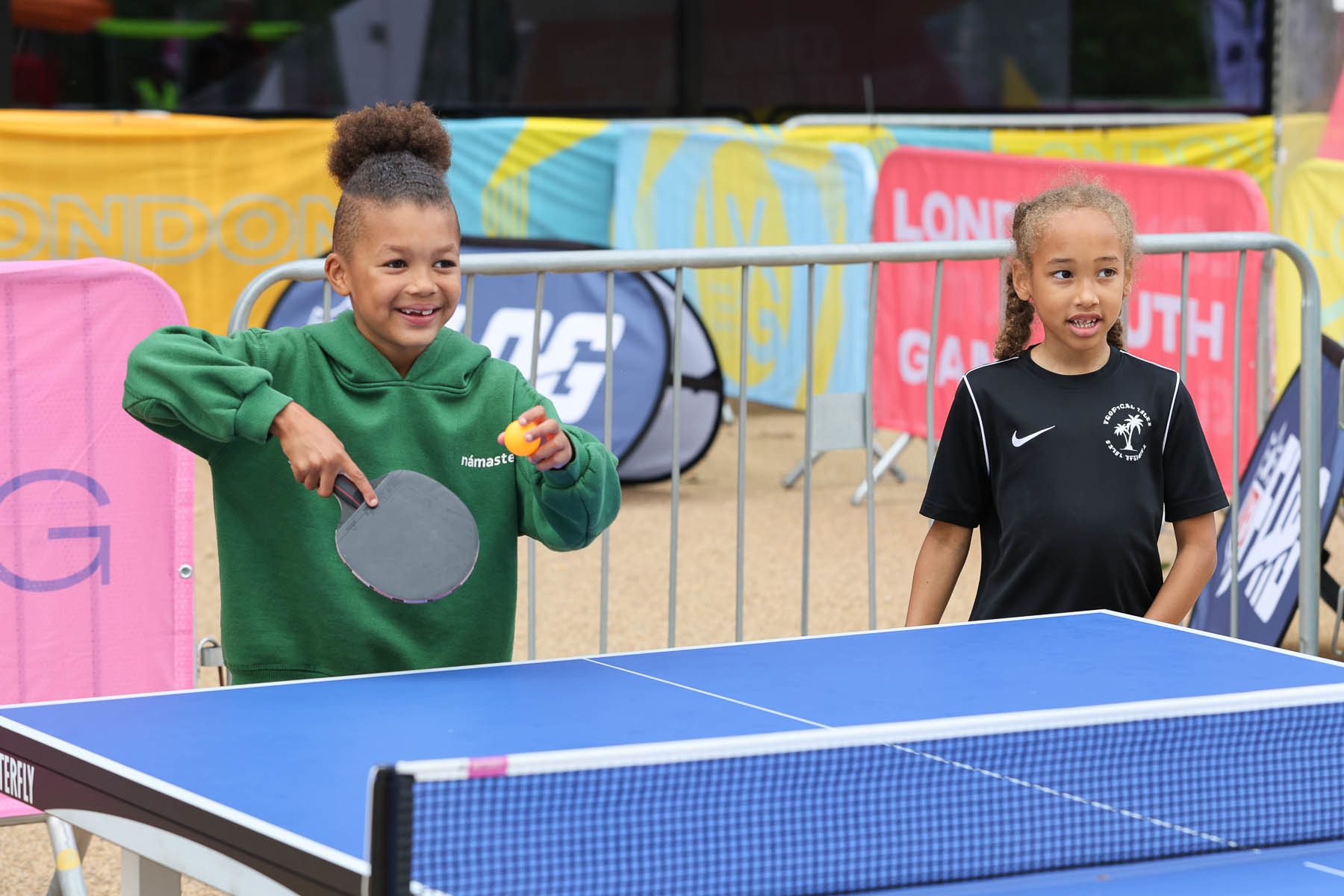 2 girls playing table tennis