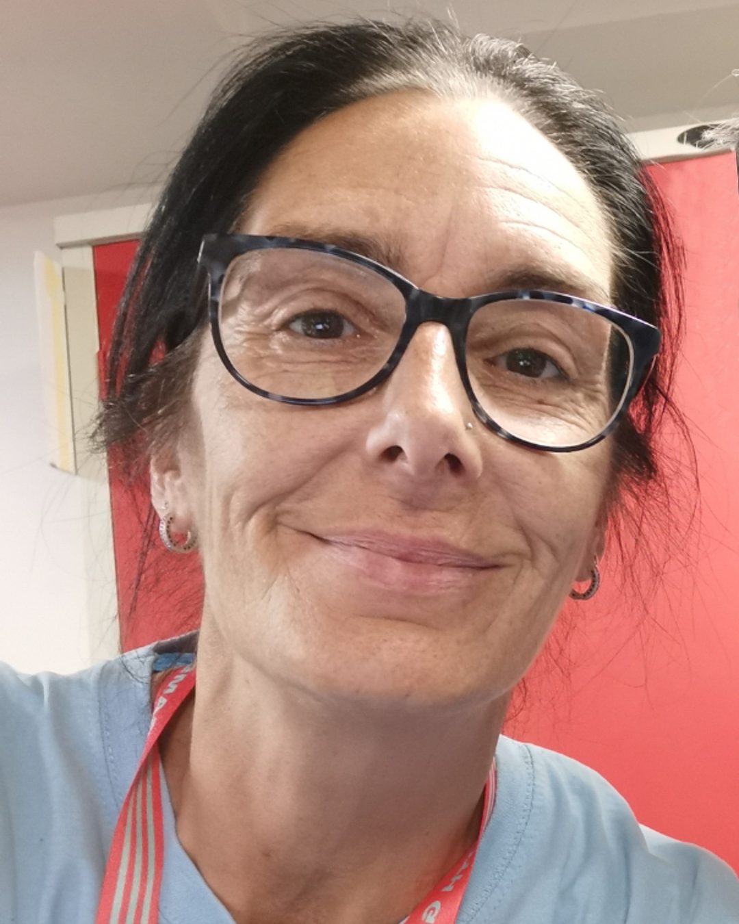 White female volunteer smiles at camera