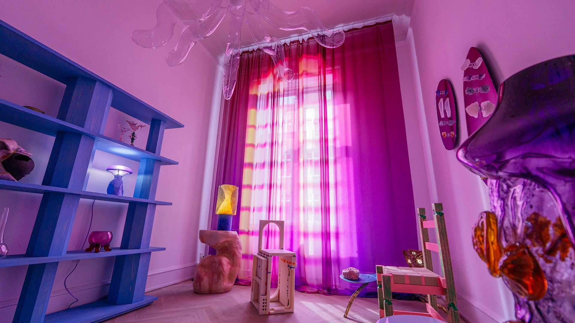 A vibrant, surreal room with purple light, a blue shelf, and abstract furniture.