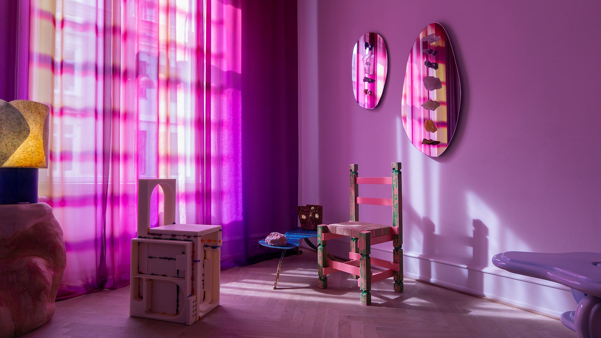 Vibrant purple room with eclectic furniture, patterned curtains, and crystal mirrors.