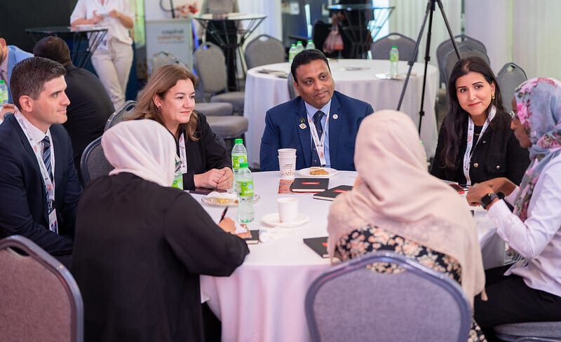 Social group, Outerwear, Furniture, Meeting, Event, Interaction, Suit, Table, Coat, Drinkware