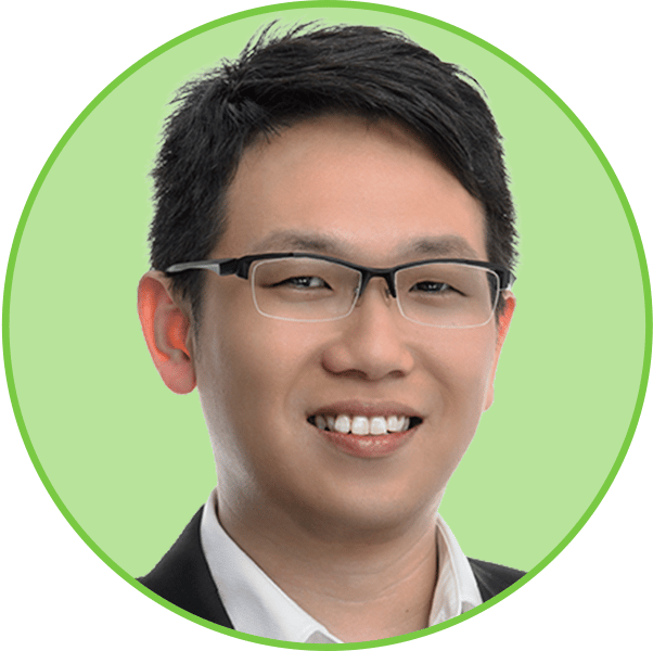 Headshot of a smiling Asian man with short dark hair and glasses on a bright green background.