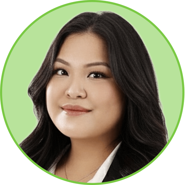 Headshot of a smiling Asian woman with long dark hair in a light green circular frame.