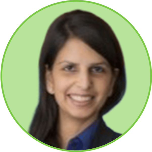 Headshot of a smiling woman with dark hair, against a light green background, framed in a circle.