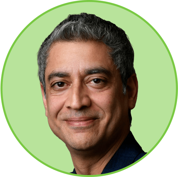 Headshot of a smiling man with grey hair.