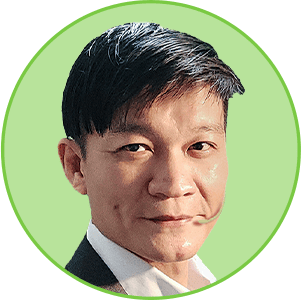 Headshot of an East Asian man wearing a suit jacket and white shirt, looking forward.