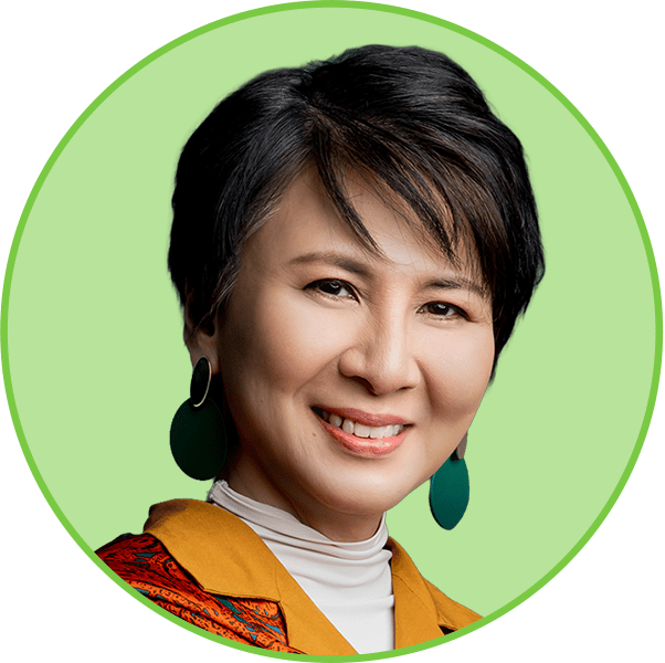 Headshot of a smiling Asian woman with short dark hair, a yellow blazer, and green earrings.
