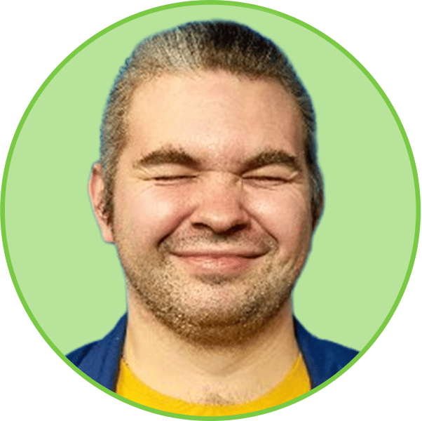 Man with eyes closed, smiling, in a green circle, wearing a yellow shirt and blue jacket.