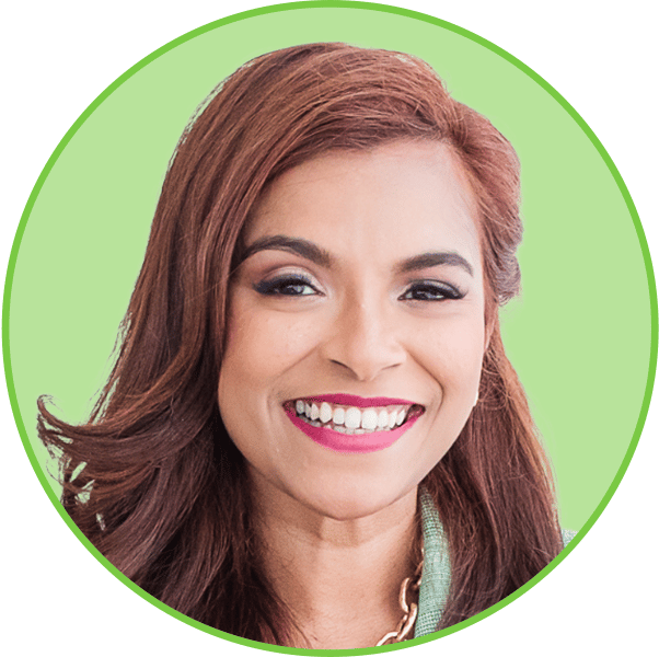 Smiling woman with long brown hair, dark eyes, and bright pink lipstick in a green circular frame.