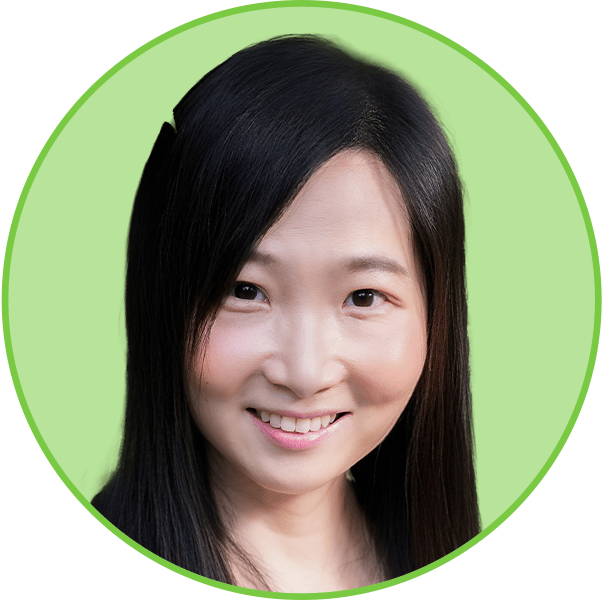 Headshot of a smiling East Asian woman with long dark hair against a green background.