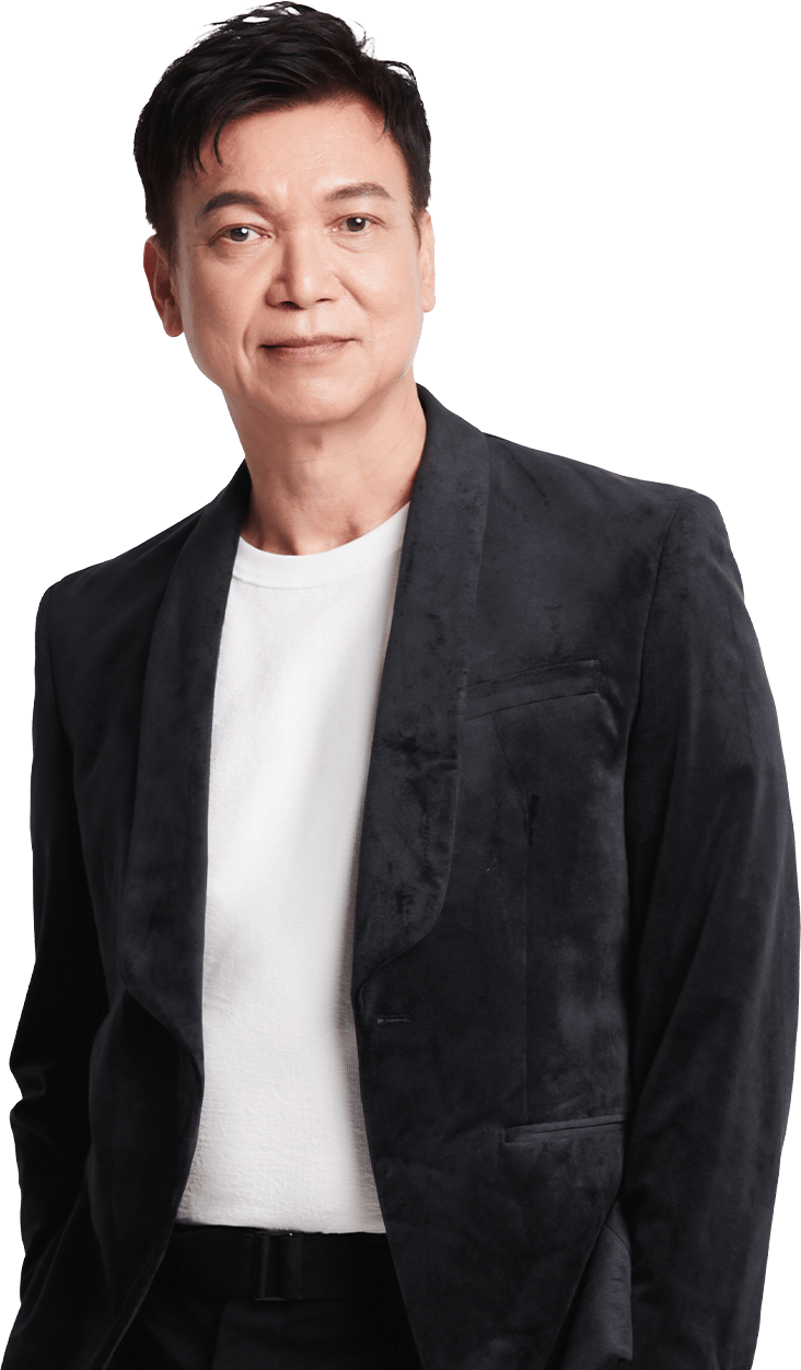 East Asian man smiling in black velvet blazer and white t-shirt.