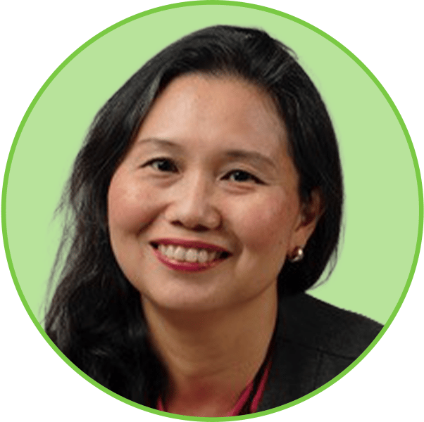 A smiling Asian woman with long dark hair, wearing a black blazer and fuchsia top.