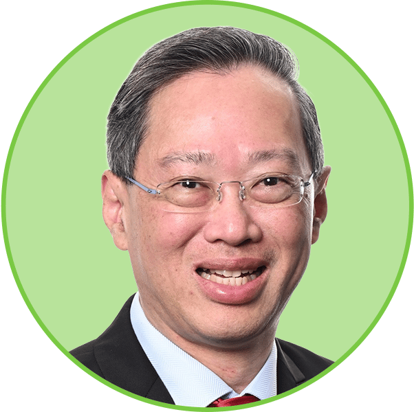Headshot of a smiling Asian man in glasses, wearing a suit and red tie.