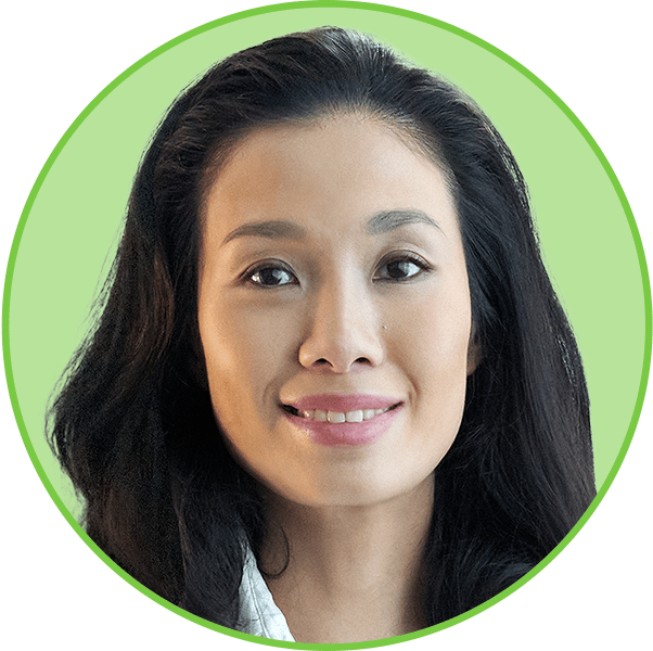 A headshot of a smiling East Asian woman with long dark hair in a light green circular frame.